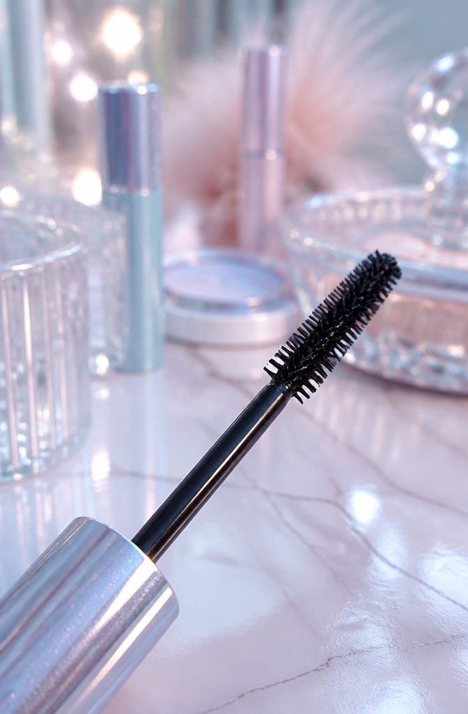 Icy Pastel Makeup: How to Create a Frosty Eye Look in 6 Steps 6 Model applying mascara to enhance her lashes.
